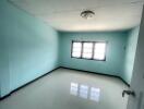 Empty bedroom with blue walls and a window