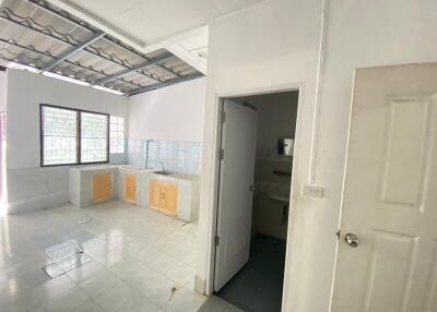 Simple kitchen layout with white tiled flooring