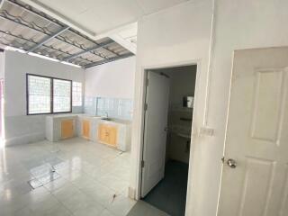 Simple kitchen layout with white tiled flooring