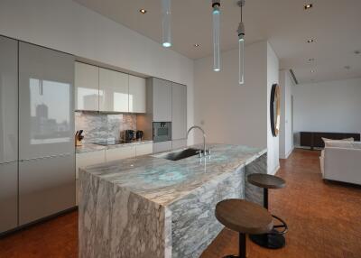 Modern kitchen with marble island and hanging lights