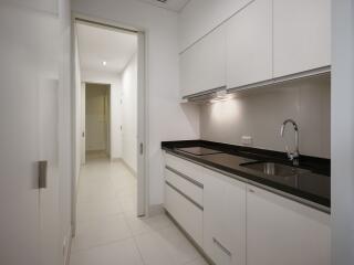 Modern kitchen with sleek cabinetry and black countertop