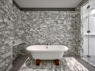 Luxurious bathroom with marble walls and standalone bathtub