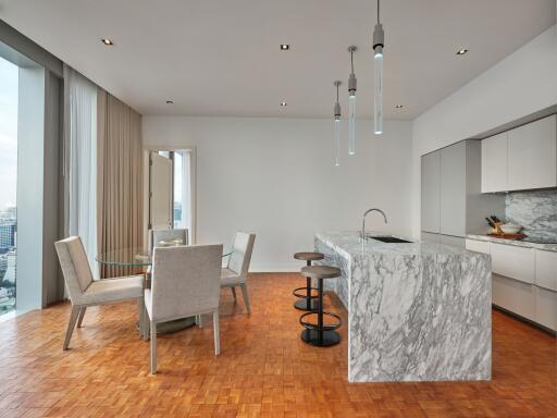 Modern kitchen and dining area with marble island