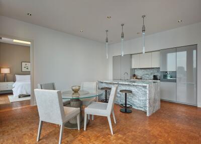 Modern open dining area with kitchen and bedroom