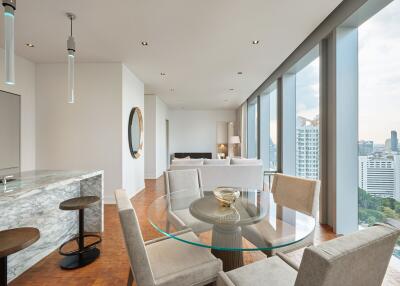 Modern open-plan living and dining area with large windows and city view