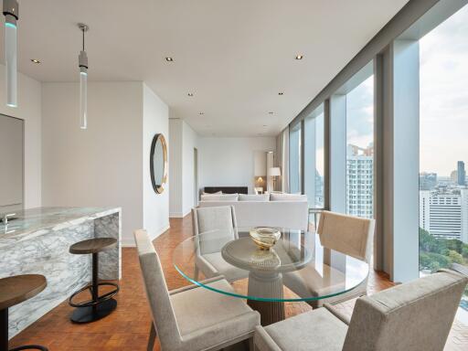 Modern open-plan living and dining area with large windows and city view