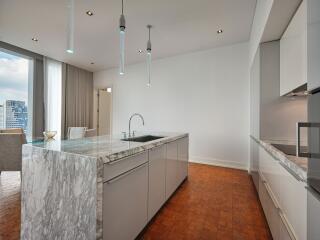 Modern kitchen with marble island and view of dining area