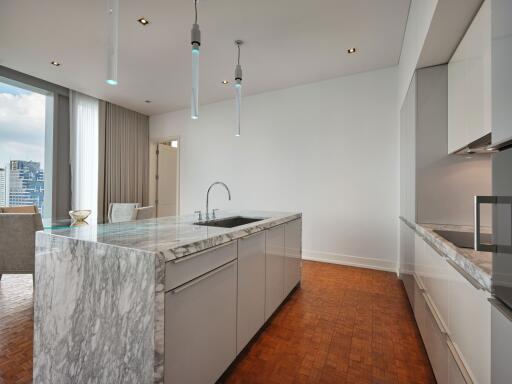 Modern kitchen with marble island and view of dining area