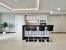 Modern kitchen with bar counter and stools