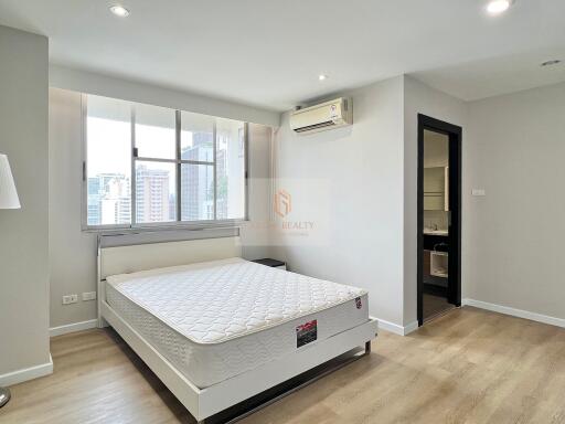 Modern bedroom with large window, hardwood floor and air conditioning unit