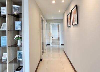 Bright hallway with built-in shelving and tiled floor