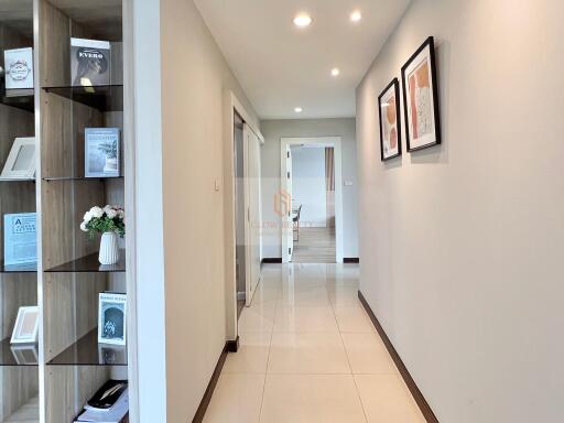 Bright hallway with built-in shelving and tiled floor