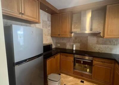 Modern kitchen with wooden cabinets and stainless steel appliances