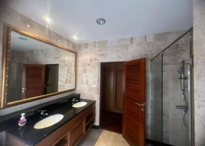 Spacious bathroom with dual sinks and a large mirror