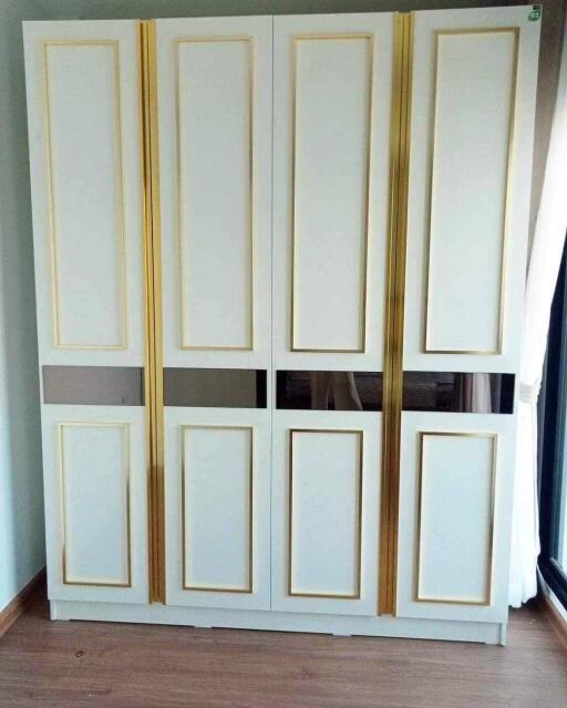 Elegant wardrobe with gold trim in a bedroom