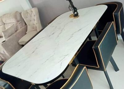 Modern dining room with a marble dining table and black chairs