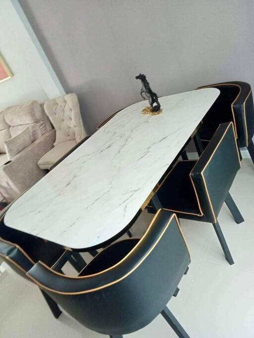 Modern dining room with a marble dining table and black chairs