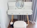 Vanity table with mirror and stool in a bedroom