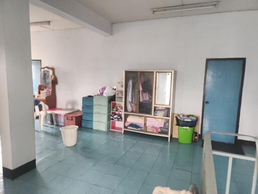 spacious bedroom with storage cabinets and blue tiled floor