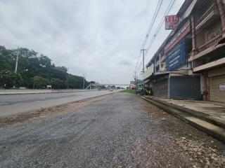 Commercial buildings along a road with cloudy sky