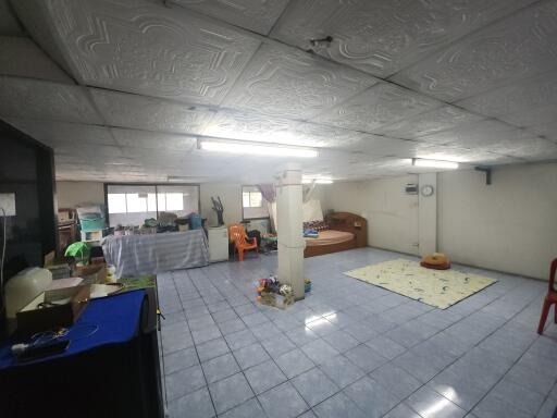 Spacious basement area with various items and furniture