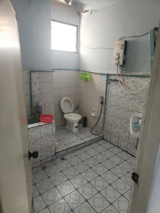 Basic bathroom with tiled floor and walls