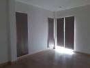 Bedroom with large windows and blinds