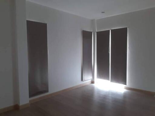 Bedroom with large windows and blinds