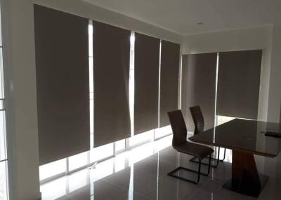 Dining area with large windows and modern furniture