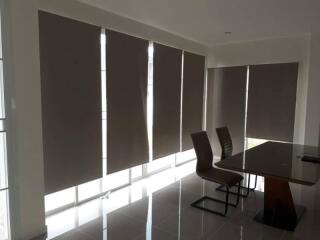 Dining area with large windows and modern furniture