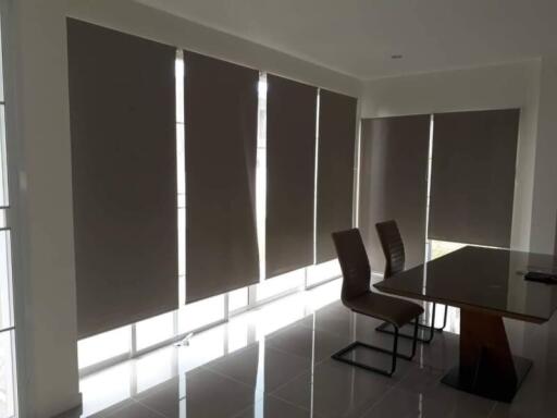 Dining area with large windows and modern furniture