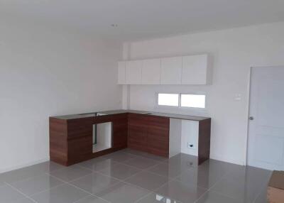 Modern clean kitchen with wooden cabinetry and white countertops