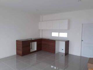 Modern clean kitchen with wooden cabinetry and white countertops