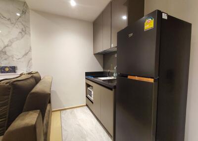 Modern kitchen with appliances and marble backsplash