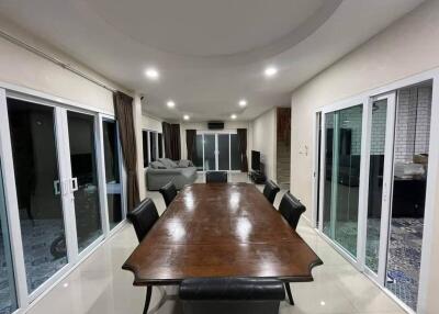 Spacious dining room with a large wooden table and sliding glass doors