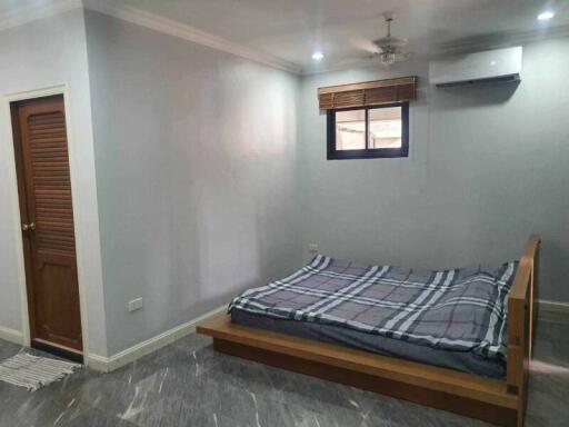 Bedroom with bed, window, and air conditioner