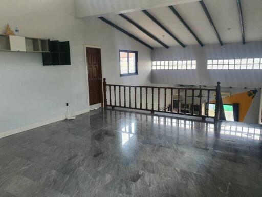 Living area with high ceiling and wooden railings