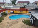 Outdoor swimming pool area with surrounding houses