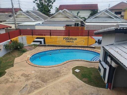 Outdoor swimming pool area with surrounding houses