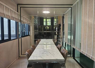 Modern dining area with a marble table and leather chairs