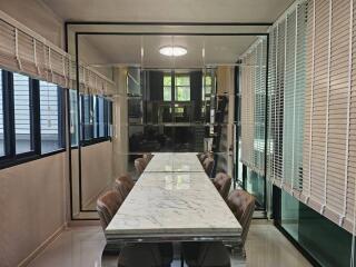 Modern dining area with a marble table and leather chairs