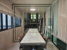 Modern dining area with a marble table and leather chairs