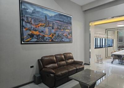 Modern living room with comfortable sofa and cityscape wall art