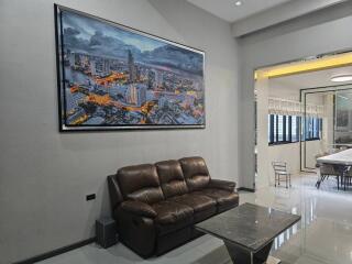 Modern living room with comfortable sofa and cityscape wall art