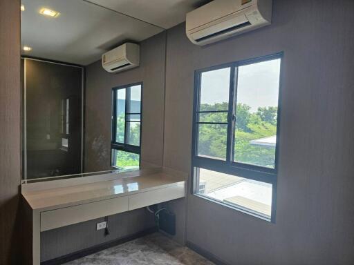 Modern bedroom with large mirror and air conditioning