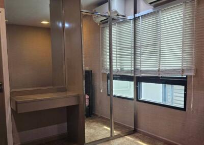 Bedroom with mirrored closet and air conditioner