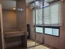 Bedroom with mirrored closet and air conditioner