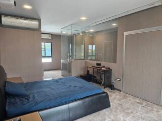 Modern bedroom with attached glass shower area