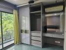 Bedroom with built-in wardrobe and sliding doors, balcony view