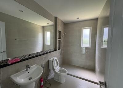 Modern bathroom with large walk-in shower and white fixtures